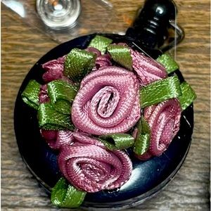 Self retracting ID card holder with beautiful roses attached